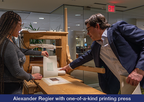 Alexander Regier with one-of-a-kind printing press